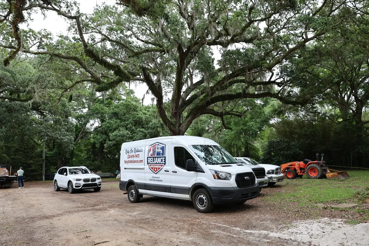 Reliance Mechanical service van parked under live oaks on the Mississippi Gulf Coast